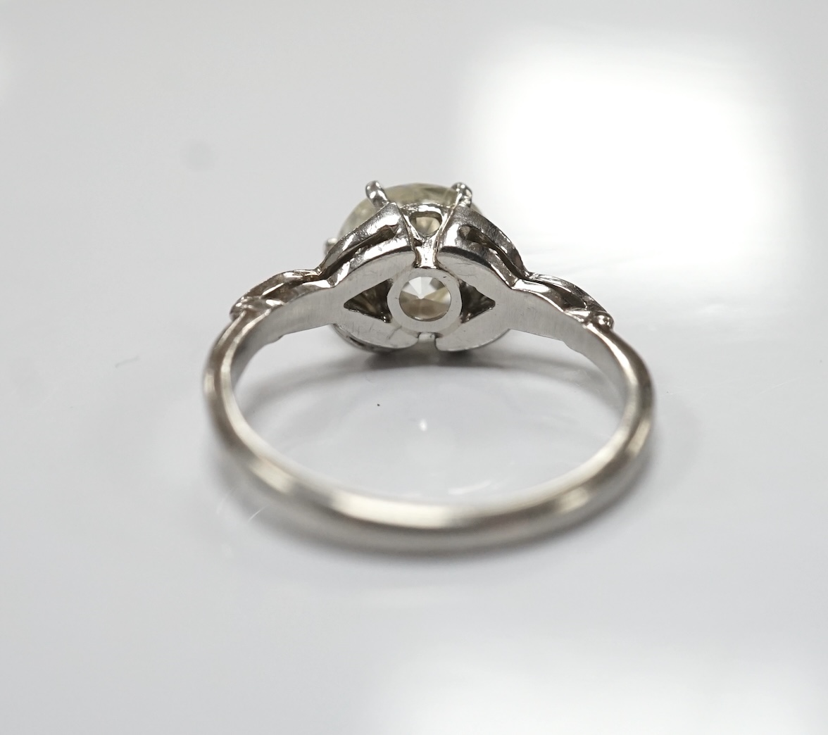 A platinum and single stone diamond set ring, with six stone diamond chip set foliate shoulders, the centre stone weighing 1.60ct, size H/I, gross weight 3.1 grams. Condition - fair